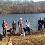 Members of MCM standing in front of a lake