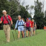 A group of MCM members hiking in a single file line