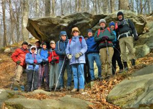 A group of MCM members standing in front of large rocks