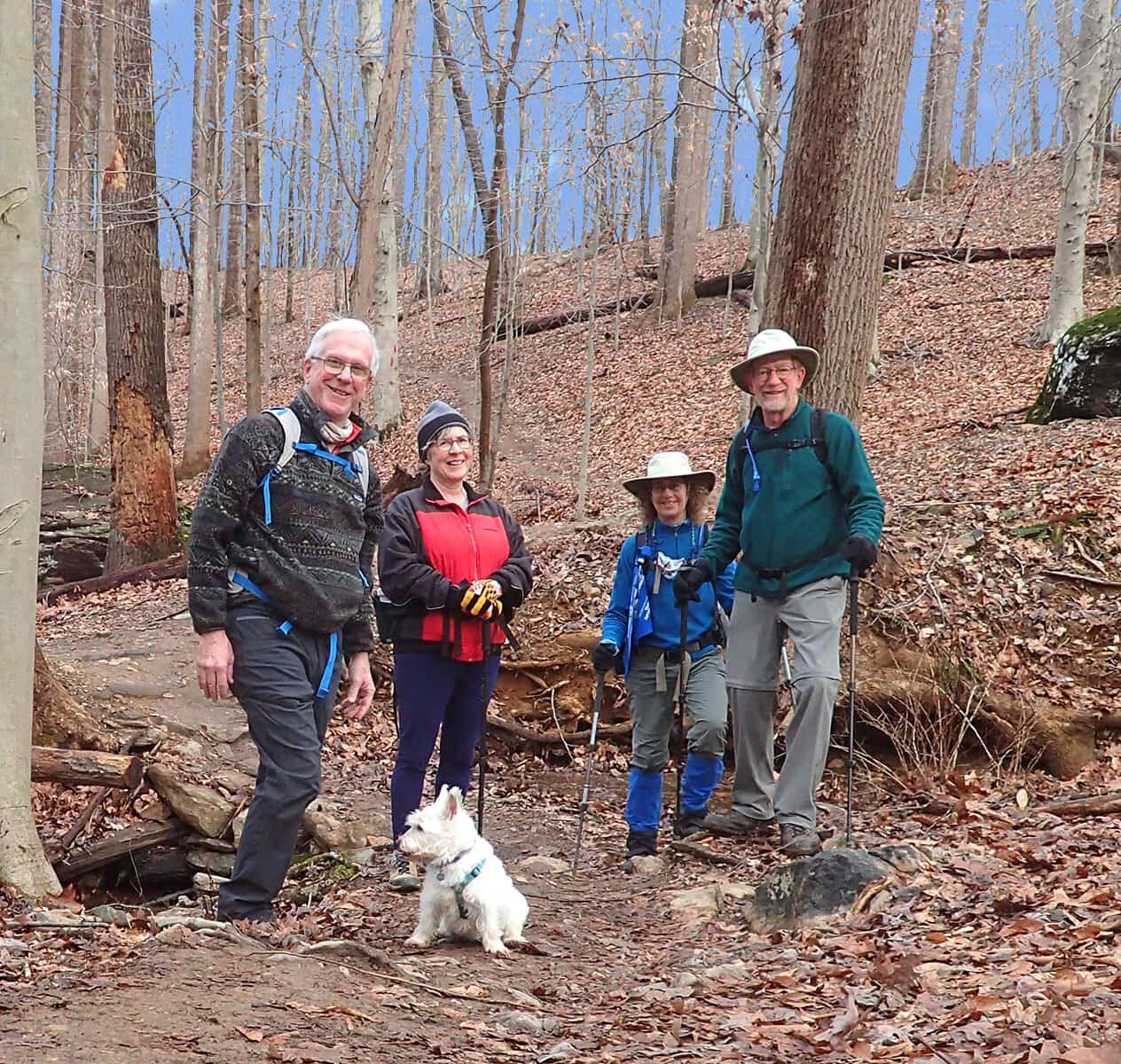 Four MCM members and a dog in the woods in autumn