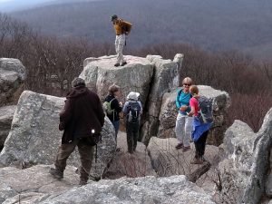 MCM members enjoying the view atop a large rock formation