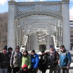 MCM members standing in front of a bridge