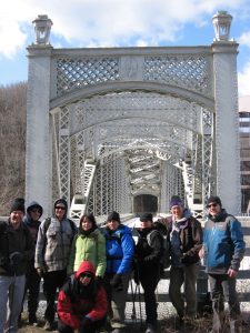 MCM members standing in front of a bridge