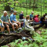 MCM members resting on a group of fallen trees